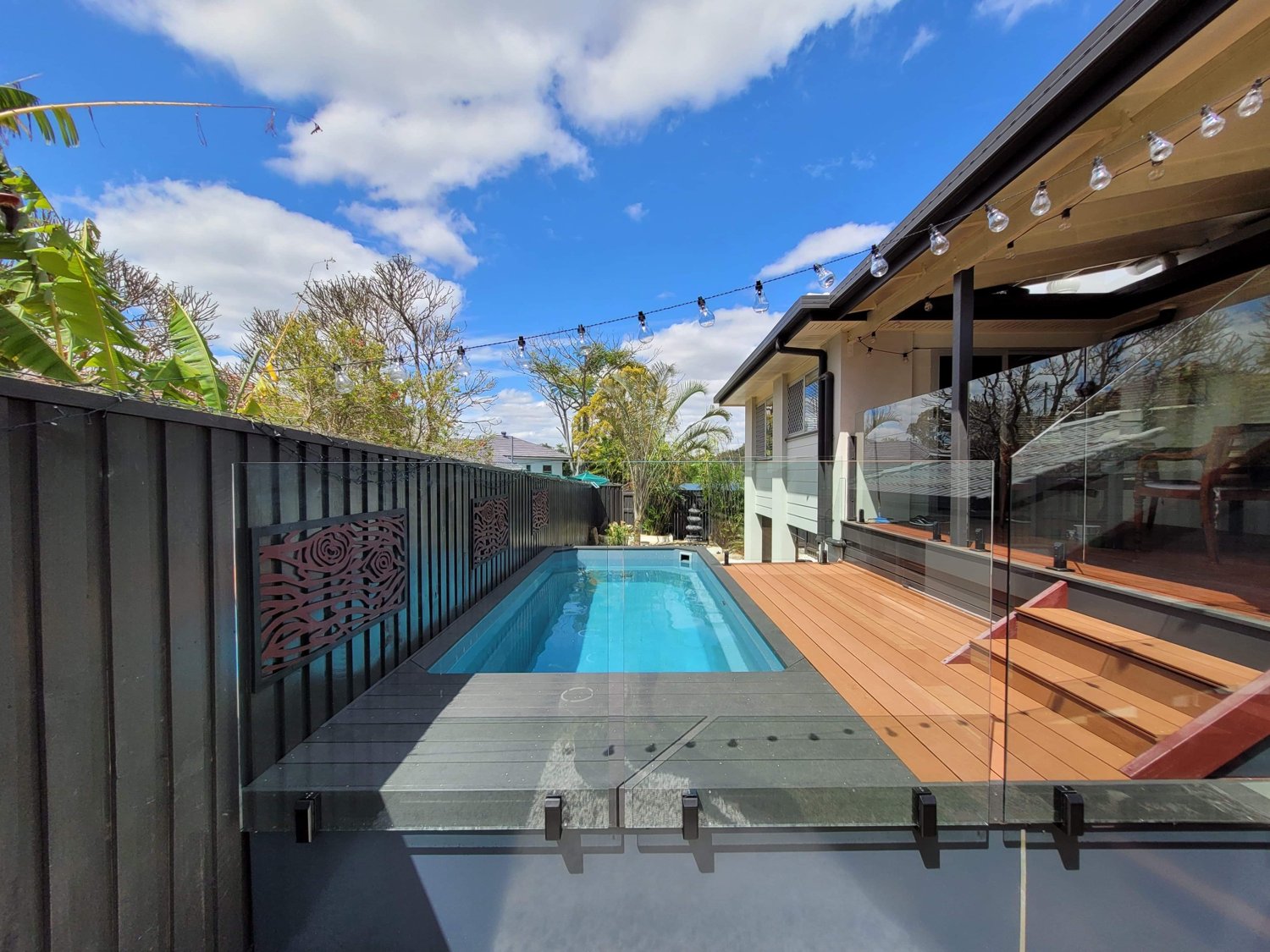 Above-ground fiberglass pool with deck